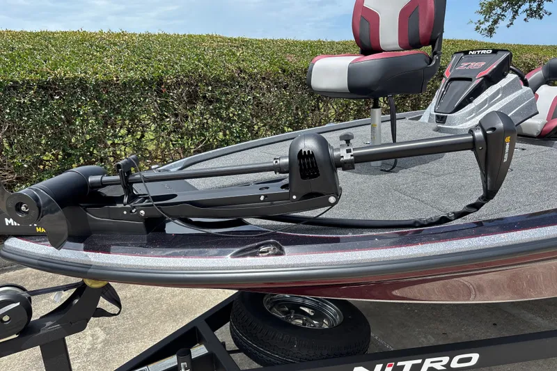 Slide: The Image of Nitro Z18 2026 boat with trolling motor and cushioned seating on trailer. - 6