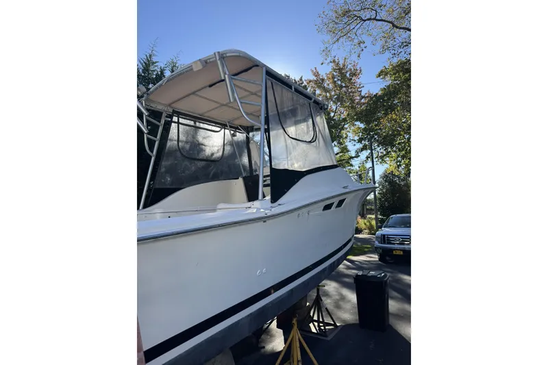 Slide: The Image of 1993 Luhr's Tournament boat with canopy, parked outdoors on a sunny day. - 4