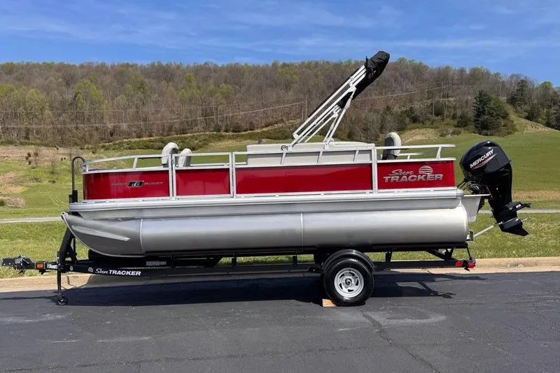 Slide: The Image of 2026 Sun Tracker Bass Buggy 18 DLX pontoon boat on trailer. - 1