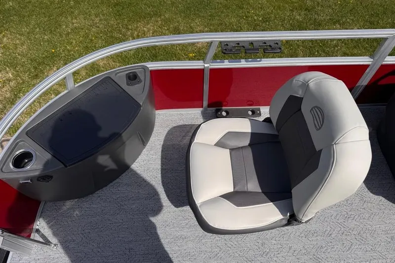 Slide: The Image of 2026 Sun Tracker Bass Buggy 18 DLX boat seat and console, red and gray interior. - 10
