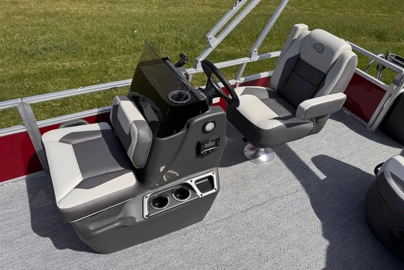 Slide: The Image of 2026 Sun Tracker Bass Buggy 18 DLX interior with dual captain chairs and steering console. - 12