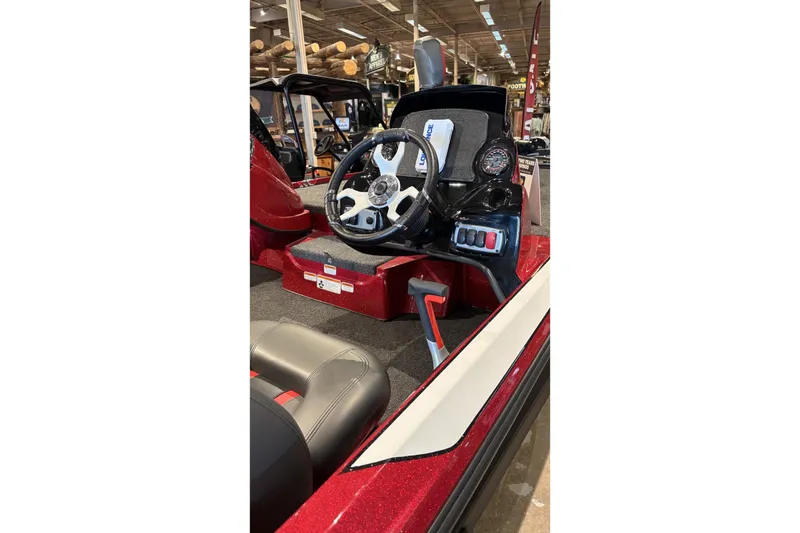 Slide: The Image of 2026 Nitro Z17 boat dashboard with steering wheel and control panel in showroom. - 2