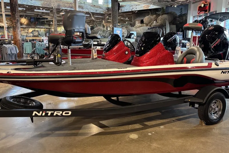 Slide: The Image of 2026 Nitro Z17 boat in showroom, featuring sleek red design and modern seating. - 4