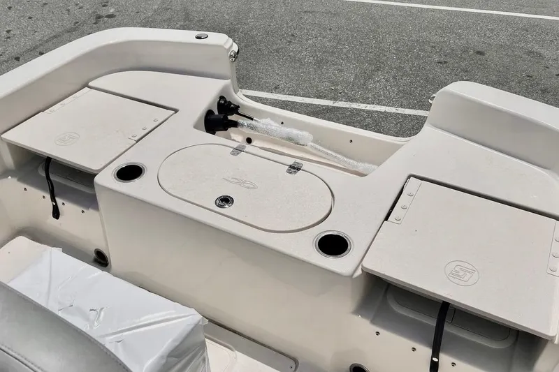Slide: The Image of 2026 Carolina Skiff 19 LS boat interior with storage compartments and cup holders. - 3
