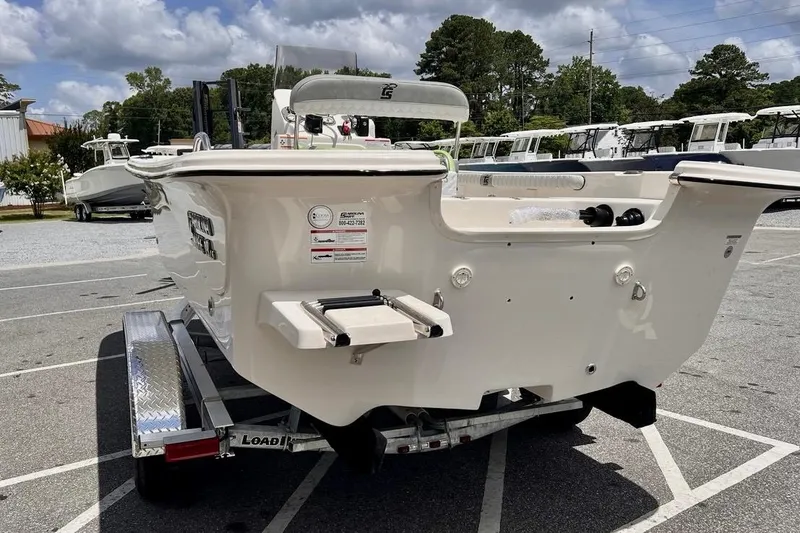 Slide: The Image of 2026 Carolina Skiff 19 LS boat on trailer, parked outdoors under cloudy sky. - 7