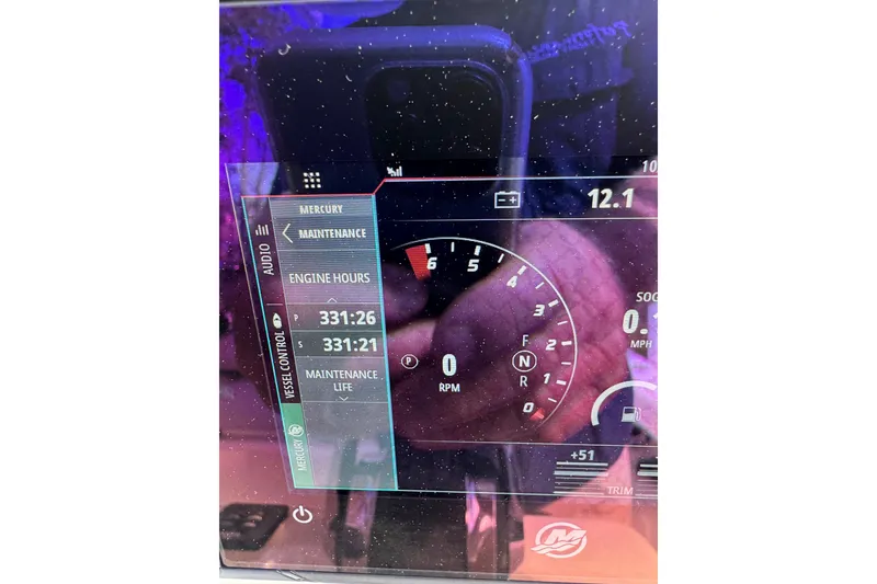 Slide: The Image of Dashboard display of a 2021 ZCB 26 Freemason showing engine hours and RPM. - 26