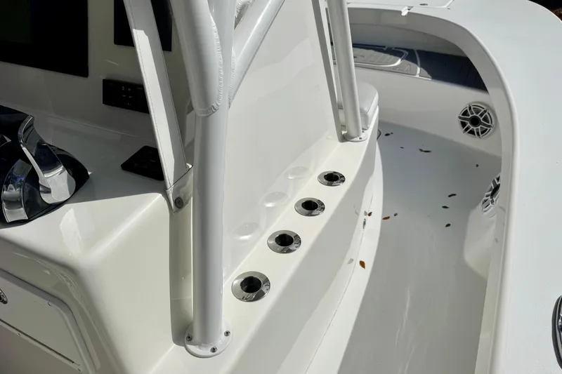 Slide: The Image of 2021 ZCB 26 Freemason boat interior with rod holders and clean white deck. - 13