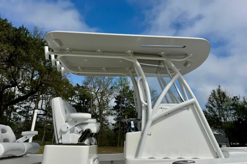 Slide: The Image of 2021 ZCB 26 Freemason boat with T-top and seating, set against a cloudy sky. - 7