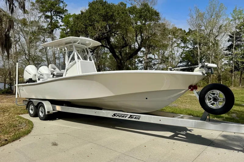 The Image of 2021 ZCB 26 Freemason boat on trailer, parked outdoors with trees in background. - 1