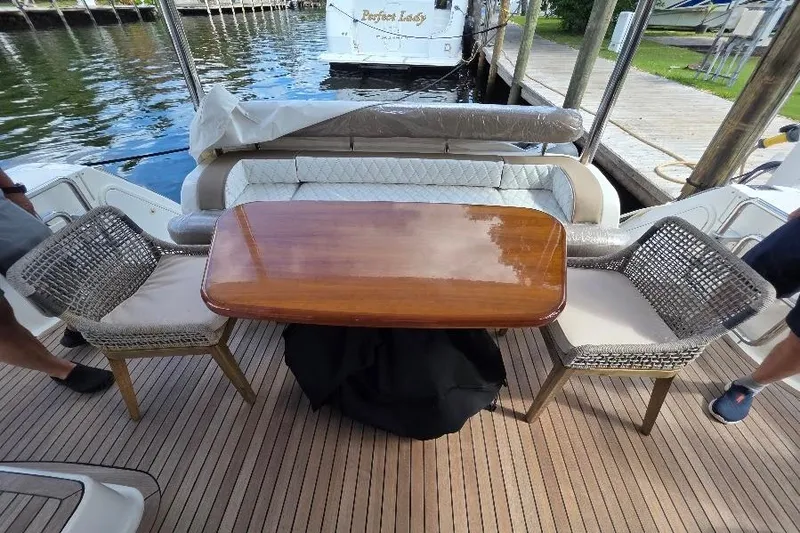 Slide: The Image of Luxury seating area on 2008 Neptunus Flybridge MY yacht with wooden table and chairs. - 12