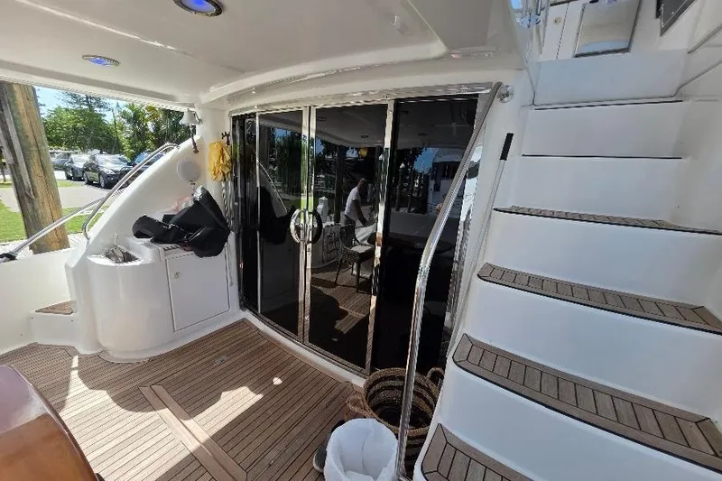 Slide: The Image of 2008 Neptunus Flybridge MY yacht interior with teak flooring and sliding glass doors. - 16