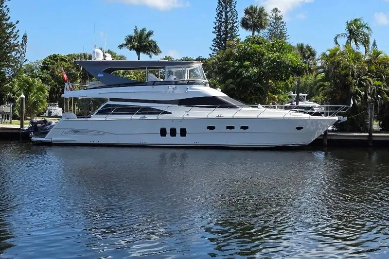 Slide: The Image of 2008 Neptunus Flybridge MY yacht docked on a serene waterway. - 2