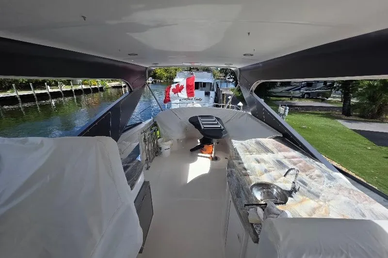 Slide: The Image of 2008 Neptunus Flybridge MY yacht interior with Canadian flag, featuring seating and kitchenette. - 20