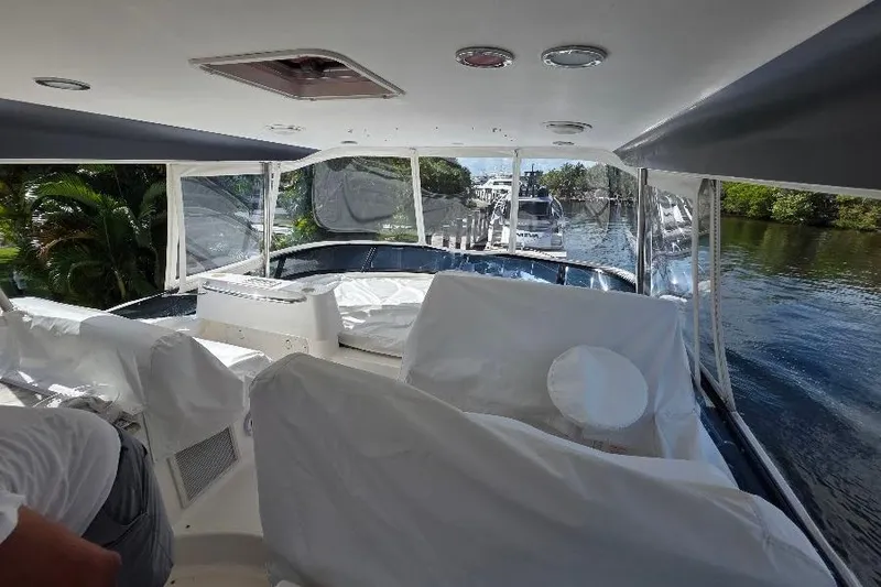 Slide: The Image of Interior view of 2008 Neptunus Flybridge MY yacht with covered seating and scenic waterway. - 21