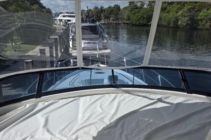 Slide: The Image of 2008 Neptunus Flybridge MY yacht docked by a serene waterfront. - 27