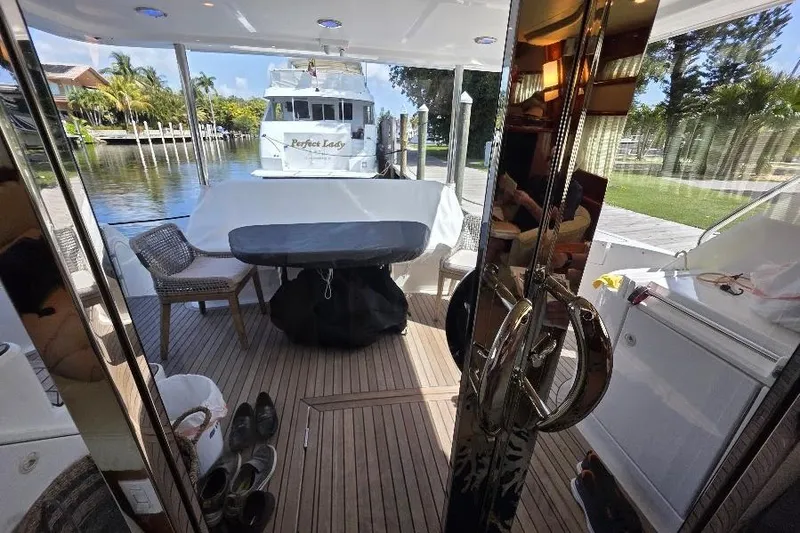 Slide: The Image of Luxurious 2008 Neptunus Flybridge MY yacht interior with outdoor seating and scenic marina view. - 44