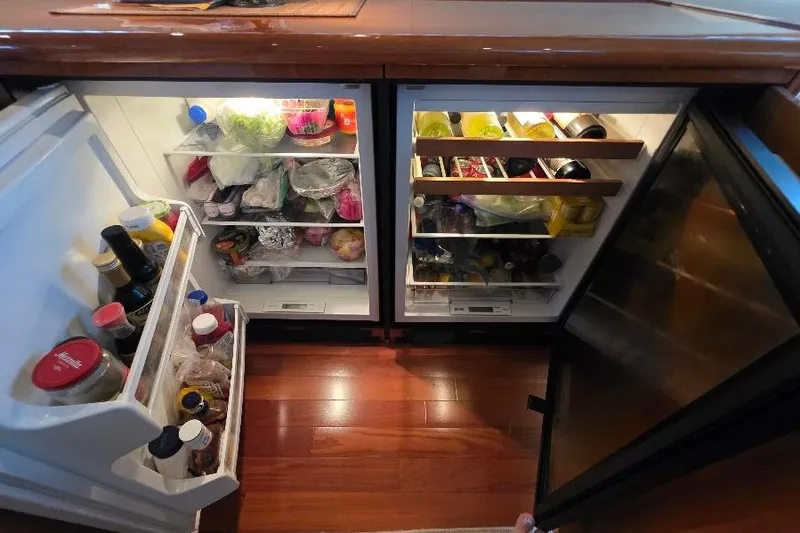 Slide: The Image of Open refrigerator on Neptunus Flybridge MY 2008 yacht, stocked with food and beverages. - 62
