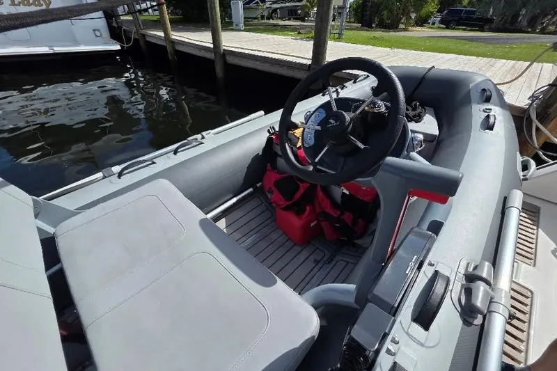Slide: The Image of Interior view of a 2008 Neptunus Flybridge MY boat with steering wheel and seating. - 9