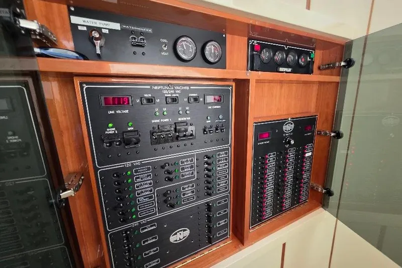 Slide: The Image of Electrical control panel of 2008 Neptunus Flybridge MY yacht, featuring gauges and switches. - 96