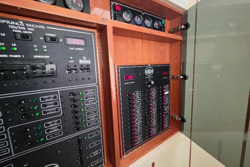 Slide: The Image of Electrical control panel of a 2008 Neptunus Flybridge MY yacht, featuring gauges and switches. - 97