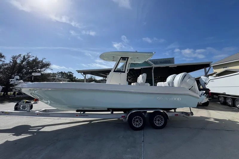 The Image of 2026 Blackwood 270 LXF boat on trailer under clear blue sky. - 1