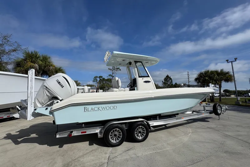 Slide: The Image of 2026 Blackwood 270 LXF boat on trailer, featuring Yamaha engine, under clear blue sky. - 10