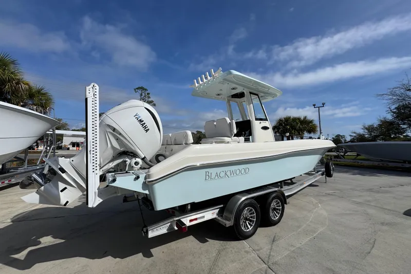 Slide: The Image of 2026 Blackwood 270 LXF boat with Yamaha engine on trailer under clear sky. - 11