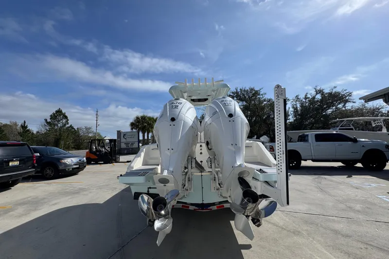 Slide: The Image of 2026 Blackwood 270 LXF boat with dual outboard engines in a parking lot. - 13
