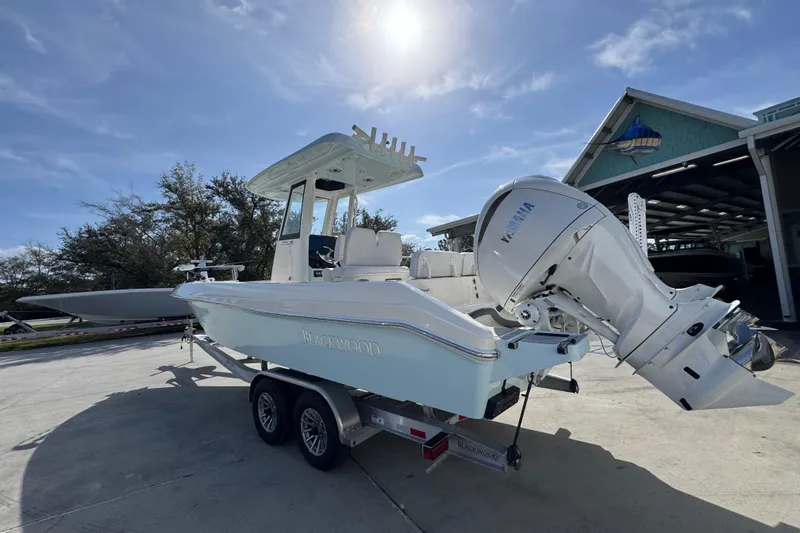 Slide: The Image of 2026 Blackwood 270 LXF boat with Yamaha engine on trailer under sunny sky. - 15