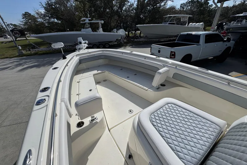 Slide: The Image of 2026 Blackwood 270 LXF boat with spacious seating and modern design in a parking area. - 18