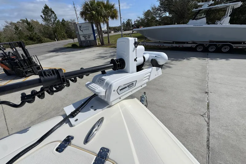 Slide: The Image of 2026 Blackwood 270 LXF boat with Minn Kota trolling motor in a marina setting. - 20