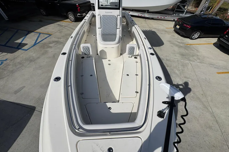 Slide: The Image of 2026 Blackwood 270 LXF boat, spacious deck view, parked in a lot. - 21
