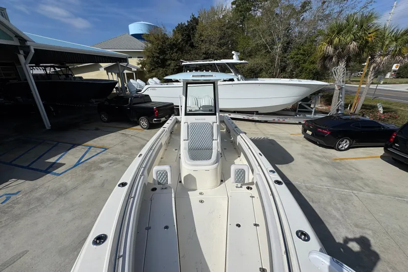 Slide: The Image of 2026 Blackwood 270 LXF boat displayed outdoors, surrounded by vehicles and trees. - 22