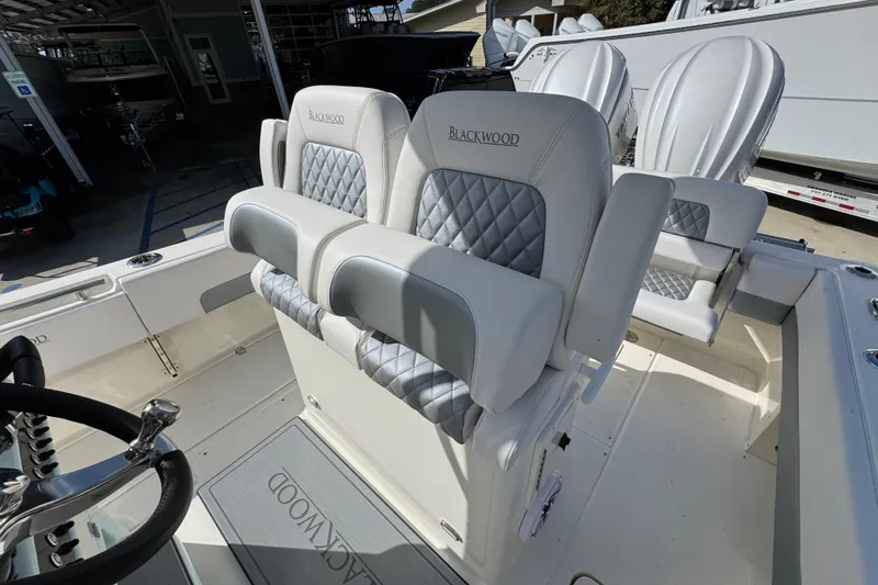 Slide: The Image of 2026 Blackwood 270 LXF boat interior with luxurious seating and steering wheel. - 26