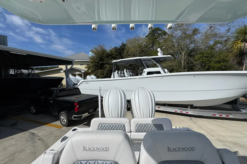 Slide: The Image of 2026 Blackwood 270 LXF boat on trailer, parked beside a black truck. - 28