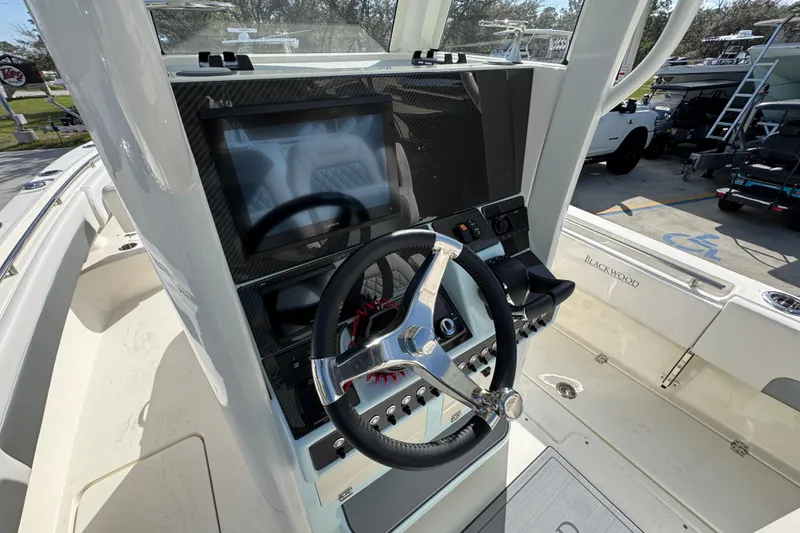 Slide: The Image of Steering console of 2026 Blackwood 270 LXF boat with touchscreen display and controls. - 30