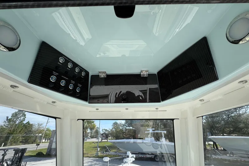 Slide: The Image of 2026 Blackwood 270 LXF boat interior with control panel and overhead storage. - 33