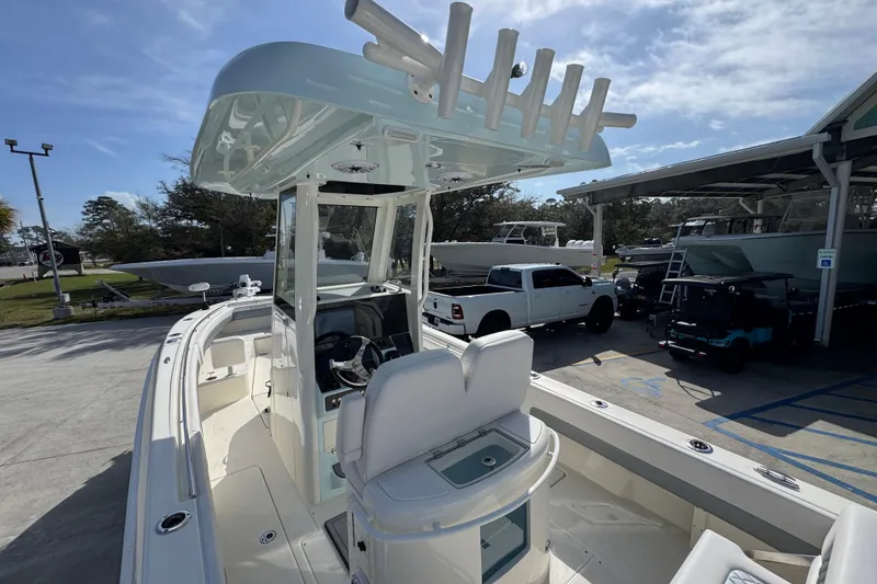 Slide: The Image of 2026 Blackwood 270 LXF boat with sleek design, docked outdoors under clear sky. - 36
