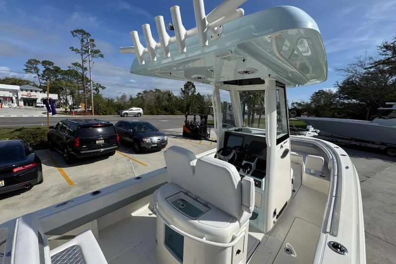 Slide: The Image of 2026 Blackwood 270 LXF boat with modern console and seating, parked outdoors. - 37