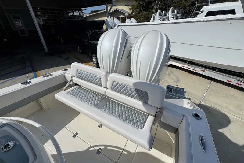 Slide: The Image of 2026 Blackwood 270 LXF boat with dual engines and cushioned seating in a marina setting. - 39