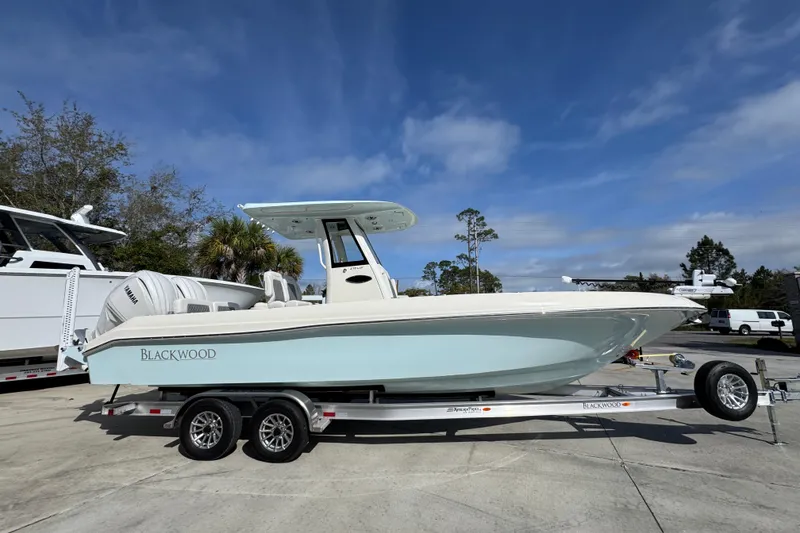 Slide: The Image of 2026 Blackwood 270 LXF boat on trailer under clear blue sky. - 9