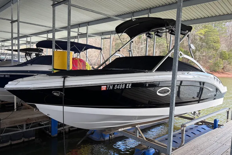 The Image of 2012 Chaparral 246 SSi boat docked under a covered marina. - 1