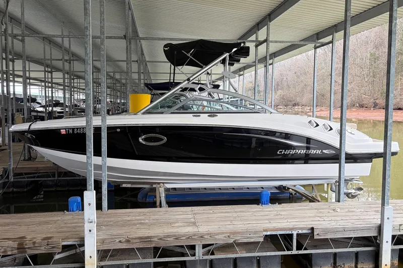 Slide: The Image of 2012 Chaparral 246 SSi boat docked in a covered marina. - 2