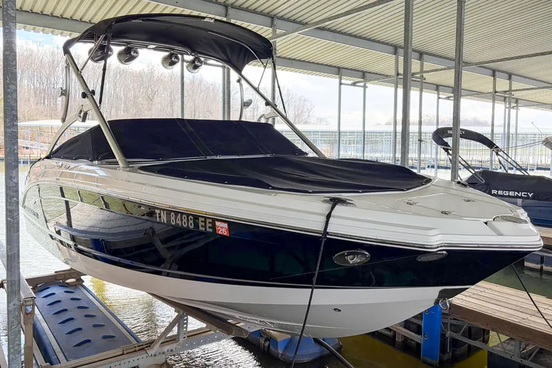 Slide: The Image of 2012 Chaparral 246 SSi boat docked under a covered marina. - 4