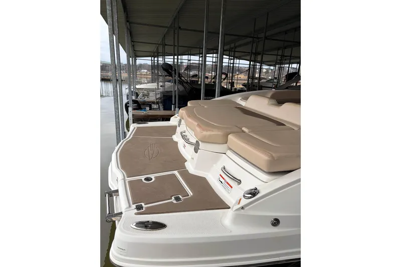 Slide: The Image of 2012 Chaparral 246 SSi boat with tan seating and swim platform in marina. - 5