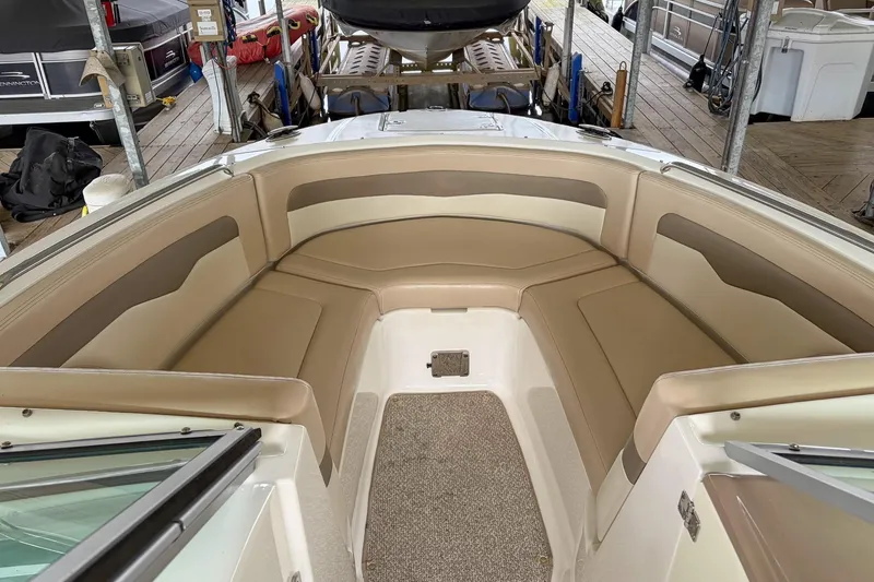 Slide: The Image of 2012 Chaparral 246 SSi boat interior with beige seating and carpeted floor. - 7