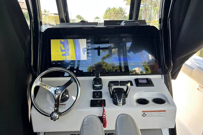 Slide: The Image of 2021 Sportsman Open 302 Center Console dashboard with steering wheel and navigation display. - 10