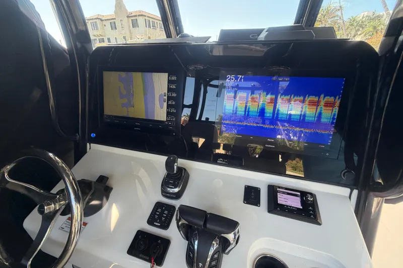 Slide: The Image of 2021 Sportsman Open 302 Center Console dashboard with navigation and control systems. - 11