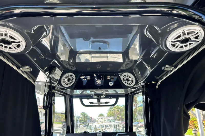 Slide: The Image of 2021 Sportsman Open 302 Center Console interior with speakers and control panel. - 13