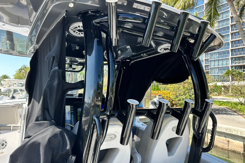 Slide: The Image of 2021 Sportsman Open 302 Center Console boat interior with rod holders and speakers. - 14